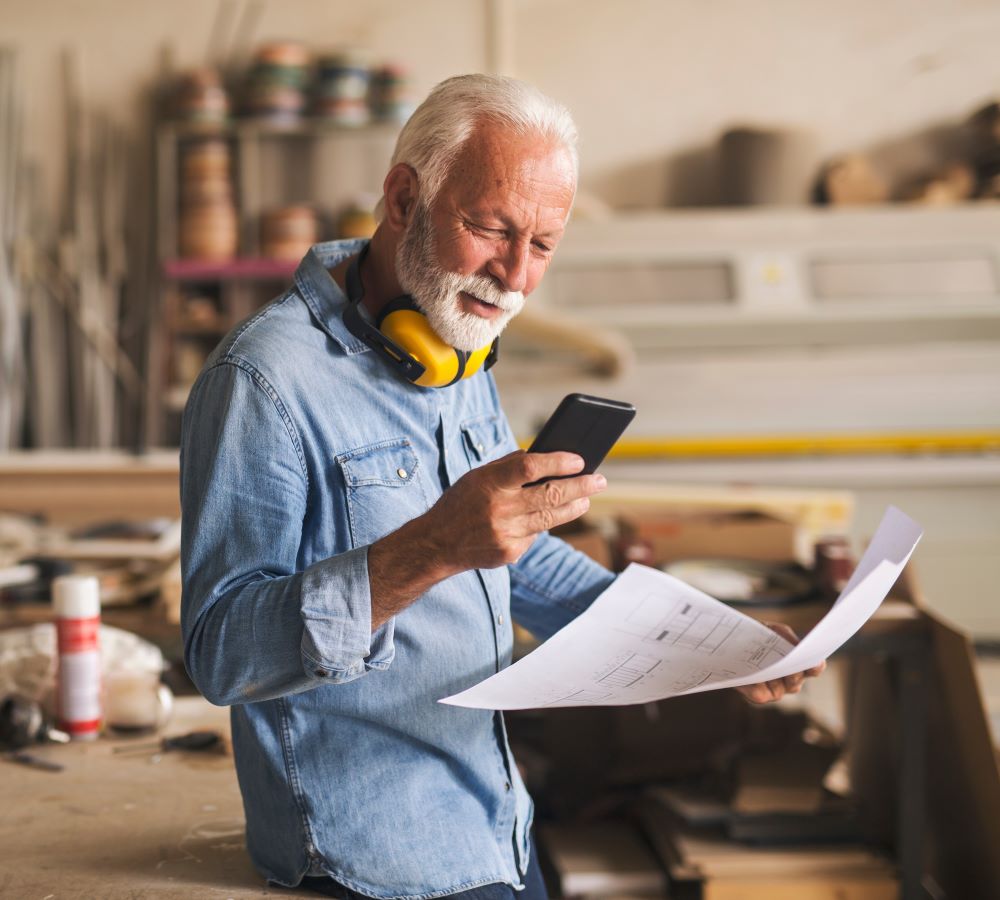 Woodworker looking at his phone