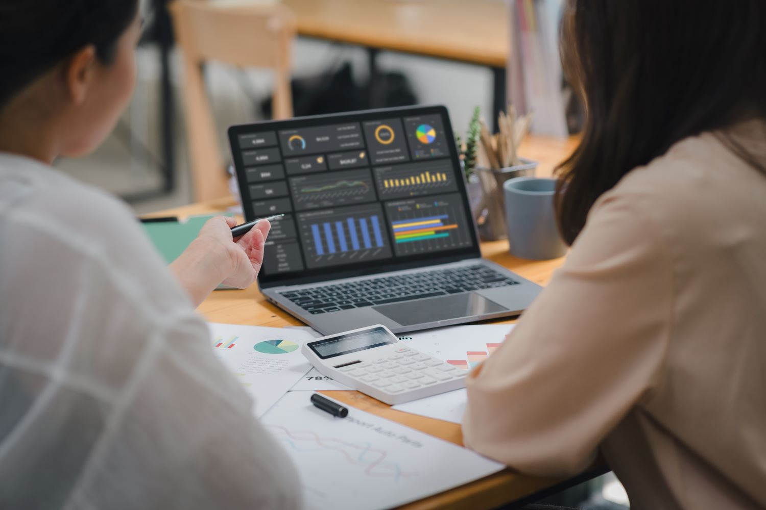 Women reviewing investment stats on a laptop