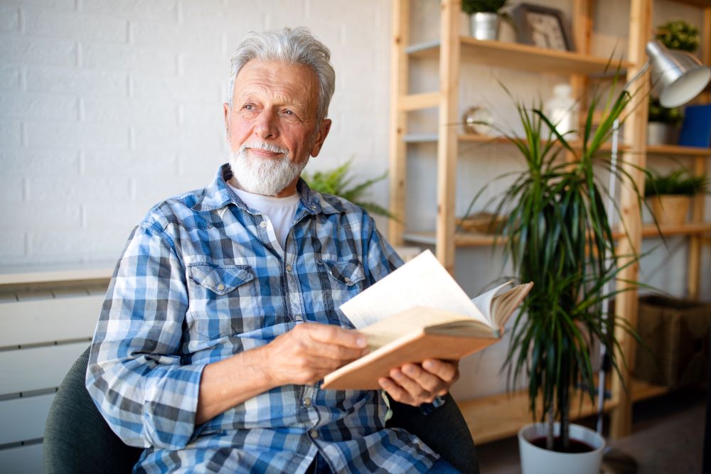 Senior man reading book at home